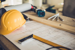 Construction hard hat and blueprints