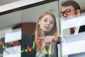 Photo of two people looking at a performance graph