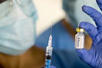 A COVID-19 vaccination shot being prepared to be administered. More than 25% of Americans have been fully vaccinated.